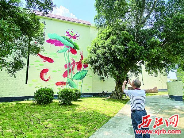 靓丽的巨幅墙绘受到村民们的赞赏。 西江日报记者 赖小琴 摄